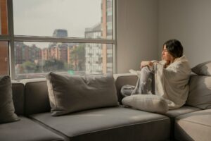 woman wrapped in blanket at home